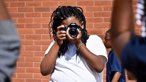 Gideons Elementary students learn the basics of photojournalism and storytelling in the Andrew P. Stewart Center's after-school program.
