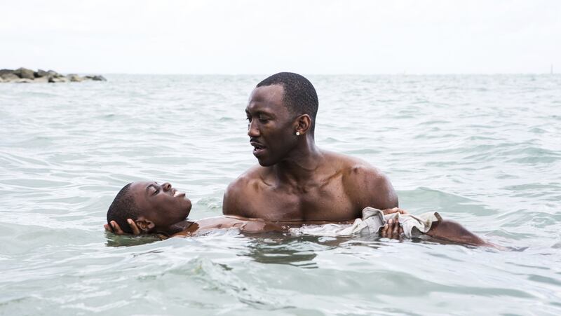 Alex Hibbert, foreground, and Mahershala Ali star in “Moonlight,” which was nominated for best original screenplay by the Writers Guild of America. (David Bornfriend/A24 via AP)