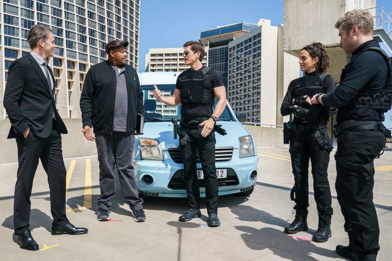 CBS's new drama "True Lies" is shot in Atlanta, which has to masquerade as a different city every episode. This backdrop is supposed to be Zurich, Switzerland, but any Atlantan familiar with downtown will recognize this skyline. Pictured L to R: Tom Connolly, Omar Miller as Gib, Steve Howey as Harry Tasker, Erica Hernandez as Maria, Mike O'Gorman as Luther. Photo: Jace Downs/CBS ©2022 CBS Broadcasting, Inc. All Rights Reserved.