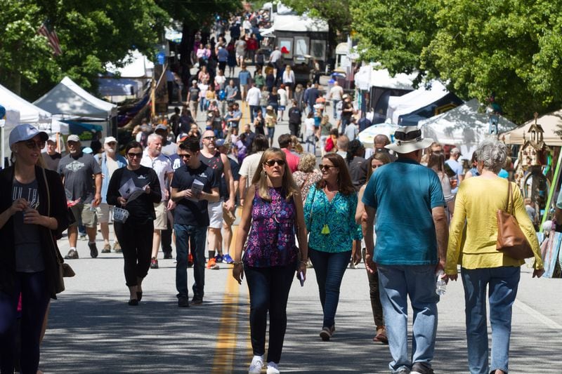 A large crowd wonders past the artist booth during the 47th Inman Park Spring Festival Sunday, April 29, 2018. STEVE SCHAEFER / SPECIAL TO THE AJC