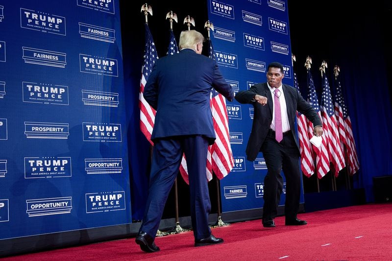 Donald Trump, left, pushed hard in a failed attempt to reverse his defeat in Georgia by spreading conspiracy theories and lies about voter fraud in the presidential election. He has continued to maintain a strong presence in Georgia, endorsing four candidates for statewide office, including U.S. Senate hopeful Herschel Walker. (Brendan Smialowski/AFP via Getty Images/TNS)
