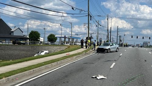 Marietta police are investigating a three-car crash that left a pedestrian dead on Cobb Parkway.