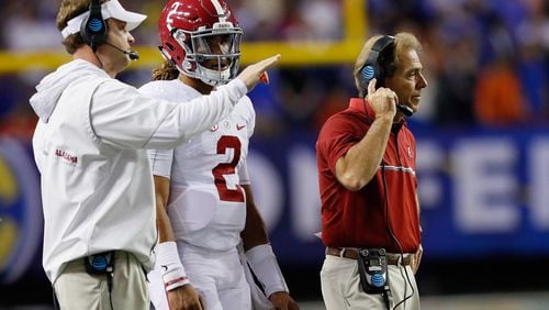 Lane Kiffin, left, talks things over with Alabama quarterback Jalen Hurts during the SEC Championship victory over Florida at the Georgia Dome. Oh, and that's Nick Saban, too. (Kevin C. Cox/Getty Images)