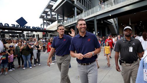 Bally Sports South and Southeast broadcasters Chip Caray (left) and Jeff Francoeur walk to a temporary broadcast area in the right-field stands for the Braves-Marlins game May 27 at Truist Park. (Jason Getz / Jason.Getz@ajc.com)