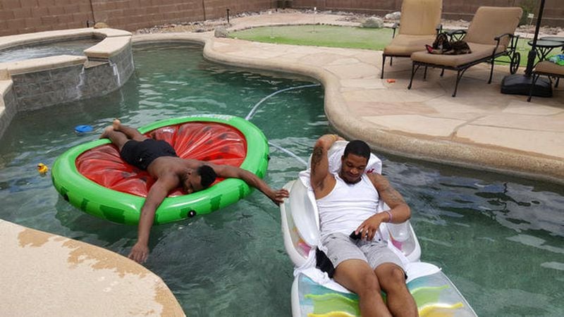 Two Georgia Tech players lounge in the backyard pool at a Tucson, Arizona, home where Ron Bell lives with his girlfriend, Jennifer Pendley. The players, Josh Okogie and Tadric Jackson, later were suspended by the NCAA for receiving impermissible benefits related to their visit to Arizona. Photo courtesy of Ron Bell.