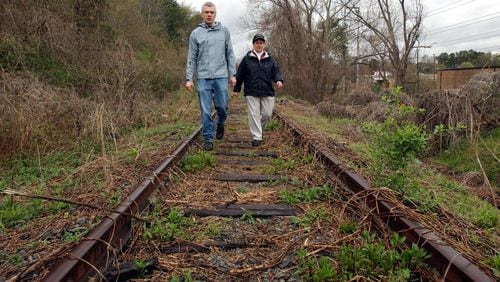 050328 - ATLANTA, GA — Friends of the Beltline co-founders Ryan Gravel and Cathy Woolard walk along a section of the Beltline near the Ansley Golf Course. (BILLY SMITH II/AJC staff)