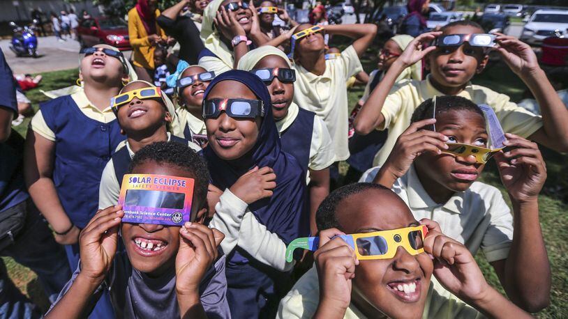 Fourth-graders and fifth-graders from the Mohammed schools of Atlanta watch the eclipse at Fernbank Science Center. JOHN SPINK/JSPINK@AJC.COM