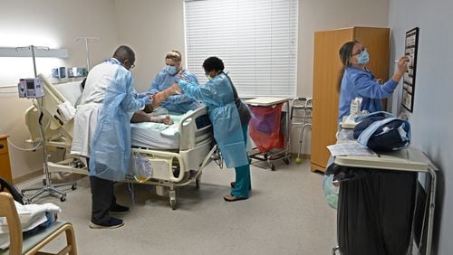 Dr. Ugo Ireh, left, and his medical staff treat a patient at Miller County Hospital in Colquitt on Monday. As other rural Georgia hospitals fight to survive, revenues of the Miller County Hospital Authority topped $66 million this year. (Hyosub Shin / Hyosub.Shin@ajc.com)