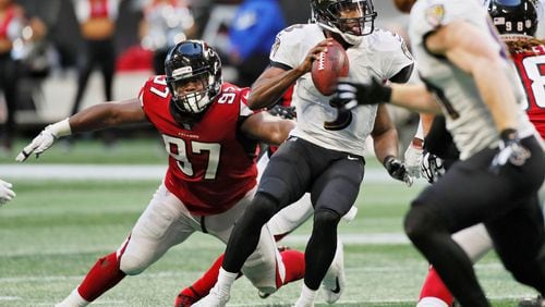 Ravens quarterback Robert Griffin III evades Falcons defensive tackle Grady Jarrett (97) in the second half Sunday, Dec. 2, 2018, at Mercedes-Benz Stadium in Atlanta.