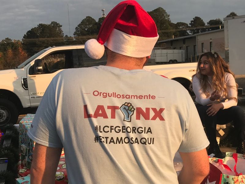 Pedro Viloria with the Latino Community Fund takes part in a Christmas parade in the town of Tifton in South Georgia on Saturday, December 4, 2021.