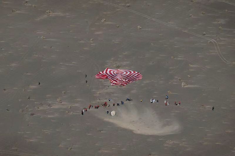 In this photo released by Xinhua News Agency, the capsule of Shenzhou-17 manned spaceship carrying astronauts Tang Hongbo, Tang Shengjie and Jiang Xinlin touches down at the Dongfeng landing site in north China's Inner Mongolia Autonomous Region, Tuesday, April 30, 2024. The return capsule of China's Shenzhou-17 manned spaceship landed back on Earth Tuesday with three astronauts who have completed a six-month mission aboard the country's orbiting space station. (Bei He/Xinhua via AP)