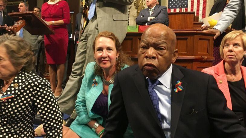 This photo provided by Rep. Chillie Pingree,D-Maine, shows Democrat members of Congress, including Rep. John Lewis, D-Ga., center, and Rep. Elizabeth Esty, D-Conn. as they participate in sit-down protest seeking a a vote on gun control measures, Wednesday, June 22, 2016, on the floor of the House on Capitol Hill in Washington. (Rep. Chillie Pingree via AP)