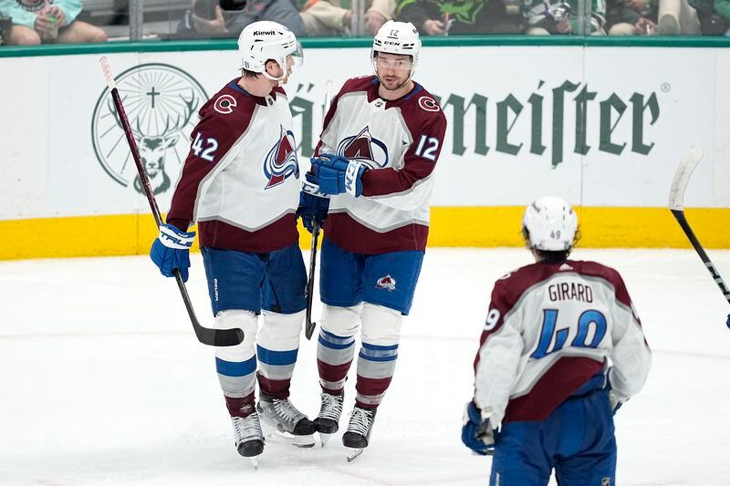 Colorado Avalanche's Josh Manson (42), Brandon Duhaime (12) and Samuel Girard (49) celebrate a goal by Duhaime against the Dallas Stars during the third period in Game 2 of an NHL hockey Stanley Cup second-round playoff series Thursday, May 9, 2024. (AP Photo/Tony Gutierrez)