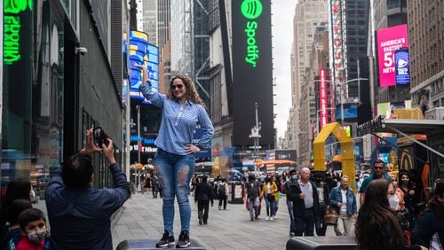 Tourists take photos in Times Square on April 29, 2021. People were injured in a shooting incident on Saturday, May 8, 2021, in the popular New York City spot. (Victor J. Blue/The New York Times)