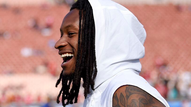 Los Angeles Rams running back Todd Gurley smiles on the sidelines before an NFL football game against San Francisco.