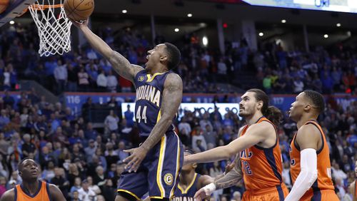Indiana Pacers guard Jeff Teague (44) goes to the basket as Oklahoma City Thunder center Steven Adams (12) and guard Russell Westbrook (0) look on during the first half of an NBA basketball game in Oklahoma City, Sunday, Nov. 20, 2016. (AP Photo/Alonzo Adams)