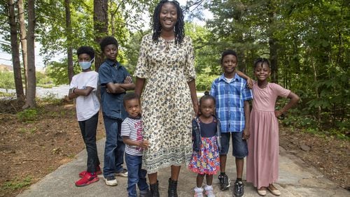 Marissa Anderson balances working at home as a 4th grade teacher at Hawthorne Elementary School with being a mom to Mark (left), Michael (second from left), Madison (right), Jacob (second from right), Isaac (third from left) and Isabella (third from right). (ALYSSA POINTER / ALYSSA.POINTER@AJC.COM)