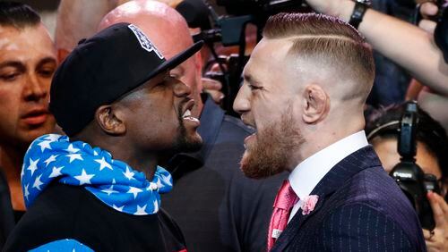 Gentlemen, start your testosterone: Floyd Mayweather Jr. and Conor McGregor face up during the Los Angeles photo op Tuesday. (AP Photo/Jae C. Hong)