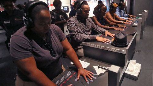 The National Center for Civil and Human Rights. First day visitors of the NCCHR at the interactive lunch counter exhibit, which recreates through an audio and visual experience what it was like to be at a lunch counter sit-in. BOB ANDRES / BANDRES@AJC.COM