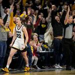 Iowa guard Caitlin Clark (22) reacts after breaking the NCAA women's career scoring record during the first half of the team's college basketball game against Michigan, Thursday, Feb. 15, 2024, in Iowa City, Iowa. (AP Photo/Matthew Putney)