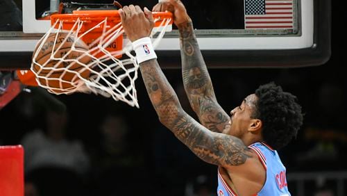 Hawks forward John Collins dunks on the Brooklyn Nets during the first quarter of an NBA basketball game, Saturday March 9, 2019, in Atlanta. (AP Photo/John Amis)