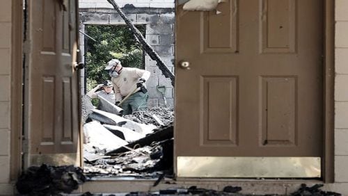 Warrenville, S.C.: Investigators examine the burned-out Glover Grove Baptist Church on Friday. As with the church that burned in Macon last week, the FBI is investigating the arson for signs that it was a hate crime.  (Todd Bennett/The Augusta Chronicle via AP)