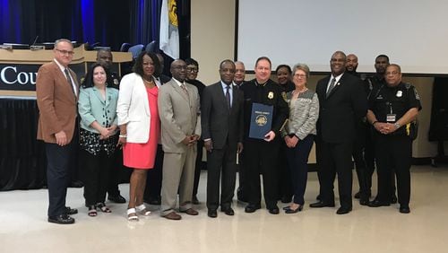 Retiring DeKalb Police Chief James Conroy was honored at the county commission meeting on April 9, 2019. He posed for photos with CEO Michael Thurmond, members of the commission and fellow officers. (TIA MITCHELL/TIA.MITCHELL@AJC.COM)