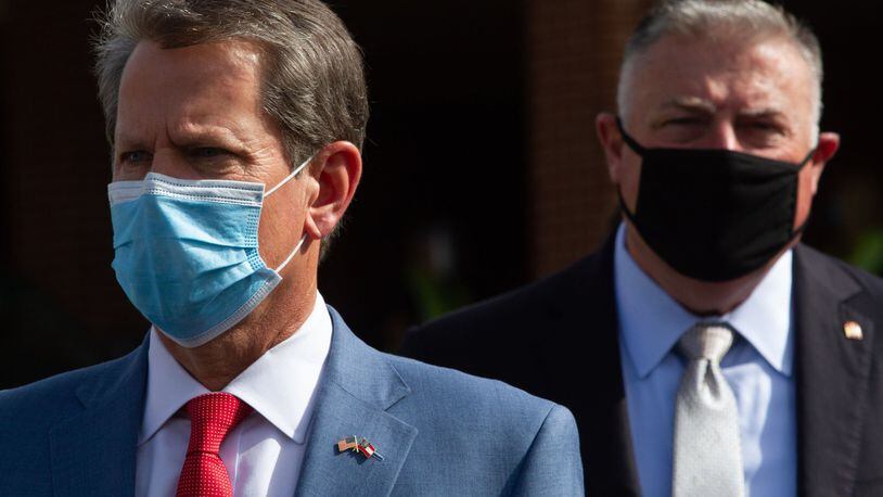 Gov. Brian Kemp, left, waits to talk with the press after touring a coronavirus testing site at Lilburn First Baptist Church in Gwinnett County on Friday, June 26, 2020. STEVE SCHAEFER FOR THE ATLANTA JOURNAL-CONSTITUTION