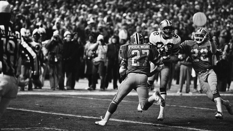 Drew Pearson (88) Dallas Cowboys wide receiver catches a pass and then scores the winning touchdown against the Atlanta Falcons in the NFC divisional playoff game in Atlanta on Jan. 5, 1981.     Falcons Tom Pridemore (27) and Rolland Lawrence (22) try but fail to stop the score which came in the final minutes of the game. Dallas won 30-27. (AP Photo)