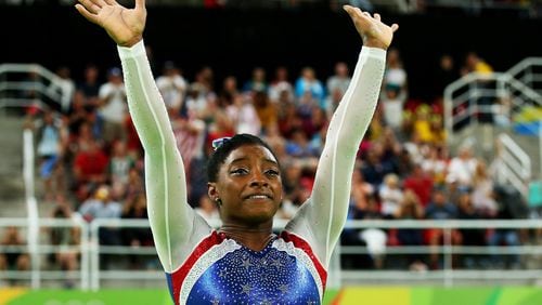 RIO DE JANEIRO, BRAZIL - AUGUST 11: Simone Biles of the United States waves to fans after winning the gold medal during the Women’s Individual All Around Final on Day 6 of the 2016 Rio Olympics at Rio Olympic Arena on August 11, 2016 in Rio de Janeiro, Brazil. (Photo by Alex Livesey/Getty Images)