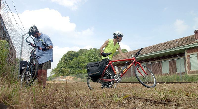 The caption on this 2004 file photo read: "The Belt Line is proposed to intersect this site at the old train depot at Memorial Drive and the Glenwood Connector. These two bike riders attended prepare to cycle away from the press conference site and are (left to right) Kevin Whited and Dennis Hoffarth. Both are sympathetic to the Atlanta Bicycle Campaign and are avid city bikers."