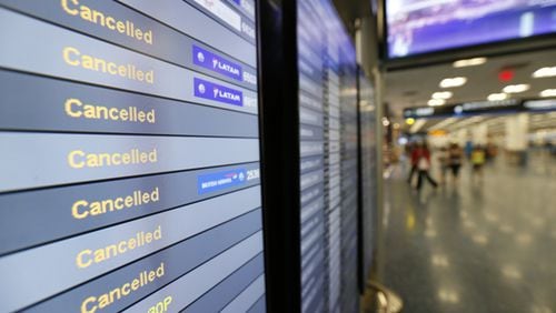 File photo, shows a monitor listing canceled flights Sept. 8 at Miami International Airport. (AP Photo/Wilfredo Lee, File)