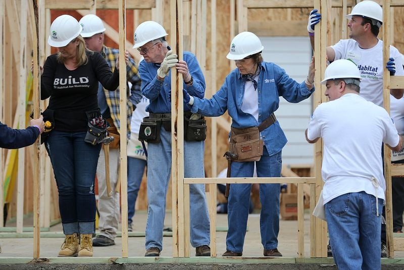 2015 (Memphis): Country musician Trisha Yearwood, from left, Former President Jimmy Carter and Former First Lady Rosalynn Carter help position an exterior wall while working on a Habitat for Humanity build. Yearwood and her husband Garth Brooks will once again join the Carters for their 2016 work project in Memphis. (BEN GRAY / AJC file)