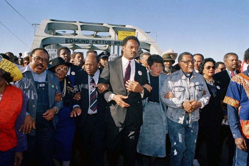 Civil rights figures lead marchers across the Edmund Pettus Bridge during the recreation of the 1965 Selma to Montgomery march in Selma, Ala., on March 4, 1990. From left are Hosea Williams of Atlanta, Georgia Congressman John Lewis, the Rev. Jesse Jackson, Evelyn Lowery, SCLC President Joseph Lowery and Coretta Scott King (glasses).