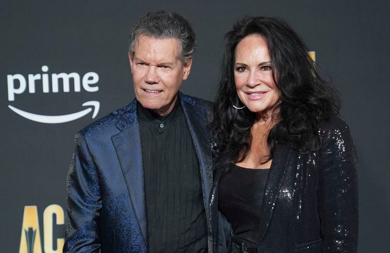 FILE - Randy Travis, left, and Mary Davis appear at the 58th annual Academy of Country Music Awards on Thursday, May 11, 2023, in Frisco, Texas. (AP Photo/Jeffrey McWhorter, File)