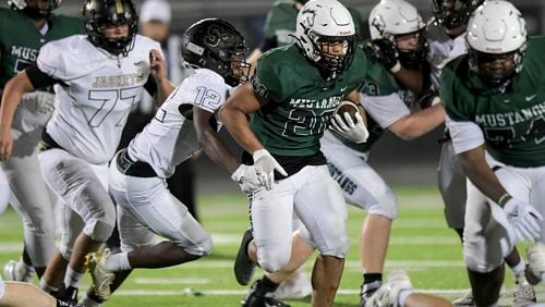 Kennesaw Mountain running back Chance Arthur (20) maneuvered the ball downfield  in the second half of play at Kennesaw Mountain High School Friday, Sept. 10, 2021. (Daniel Varnado/For the AJC)