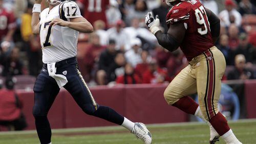 San Diego Chargers quarterback Philip Rivers (17) passes in front of San Francisco 49ers defensive end Bryant Young (97) in the first quarter of their NFL football game, Sunday, Oct. 15, 2006 in San Francisco. The 49ers lost to the San Diego Chargers 48-19. (AP Photo/Paul Sakuma)