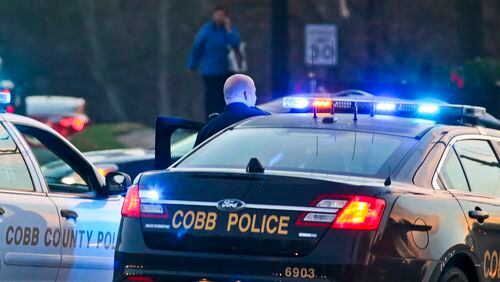 Cobb County police officers at a crime scene on March 12, 2015. JOHN SPINK/ JSPINK@AJC.COM/ 2015 ajc file photo