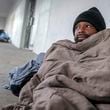 In January, Antwan Slaton bundled up as best he could in Atlanta as temperatures dropped into the teens. Slaton spent the night on a concrete sidewalk outside the South Rhodes Center in Midtown. (John Spink / John.Spink@ajc.com)