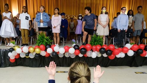 Fifth graders sing a song on stage at their graduation ceremony at Hawthorne Elementary School in Atlanta on Friday, May 20, 2022. Hawthorne Elementary is one of 16 schools in the DeKalb County district recognized for having the most improvement in content mastery scores on state assessments in recent years. (Arvin Temkar / arvin.temkar@ajc.com)