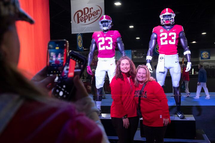 Lindsey Verran, from Minneapolis, left, and Michelle Cowan, from Charlotte, pose for a photo at the entrance to the SEC FanFare in Atlanta on Friday, Dec. 1, 2023.   (Ben Gray / Ben@BenGray.com)