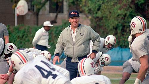 FILE - In this Dec. 27, 1988, file photo, Auburn football coach Pat Dye walks through his players as they begin workouts in preparation for the Sugar Bowl in New Orleans. Former Auburn coach Pat Dye, who took over a downtrodden football program in 1981 and turned it into a Southeastern Conference power, has died. He was 80. Lee County Coroner Bill Harris said Dye passed away Monday, June 1, 2020, at the Compassus Bethany House in Auburn, Ala.(AP Photo/Bill Haber, FIle)