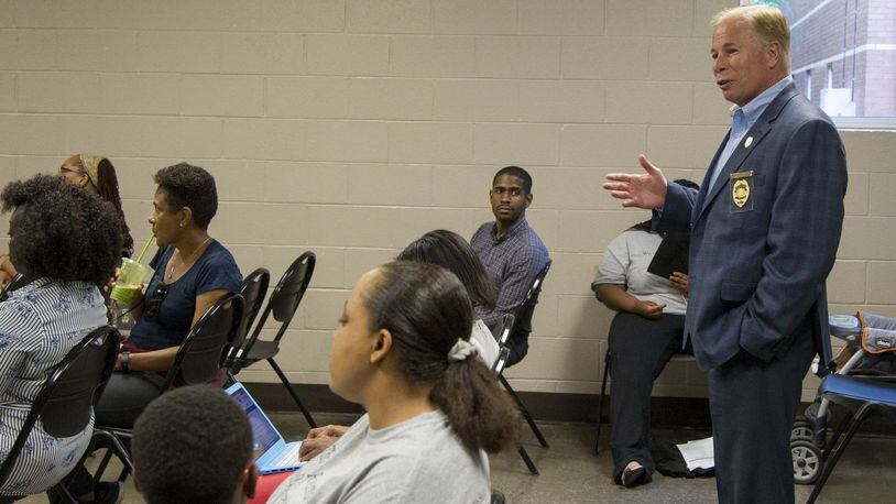 Cobb Police Chief Mike Register speaks with renters in South Cobb at the South Cobb Recreation Center in Austell on May 9. Register has been in his position for almost a year and has made it to a priority to address community-police relations. (REANN HUBER/REANN.HUBER@AJC.COM)