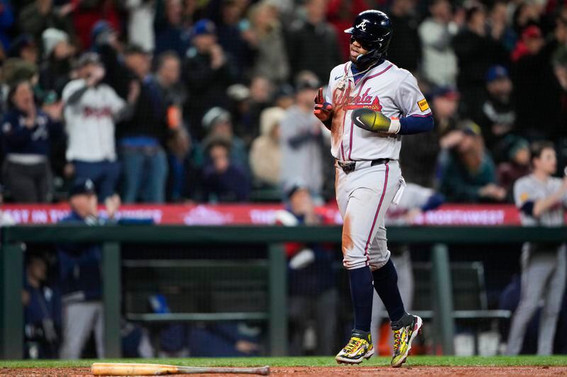 Atlanta Braves' Ronald Acuña Jr. scores on an RBI double from Ozzie Albies against the Seattle Mariners during the seventh inning of a baseball game Monday, April 29, 2024, in Seattle. (AP Photo/Lindsey Wasson)