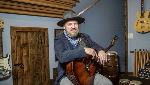 Musician John Driskell Hopkins of the Zac Brown Band sits for a portrait at his studio in Sandy Springs on Feb. 4, 2021. (Alyssa Pointer / The Atlanta Journal-Constitution)