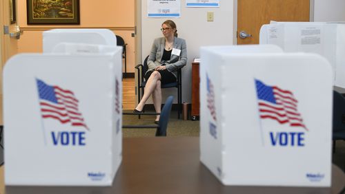 Poll worker Brittni Nix waits to assist voters during special election voting at city hall to fill an empty city council seat on Tuesday, March 24, 2020, in Dacula. The voting happens to occur on a day that was supposed to be the test run for the state's new election system before coronavirus COVID-19 caused it to be called off.