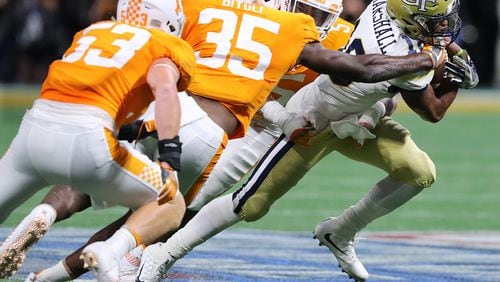 Georgia Tech quarterback TaQuon Marshall tries to run through three Tennessee defenders in the second quarter Monday night. (Curtis Compton/ccompton@ajc.com)