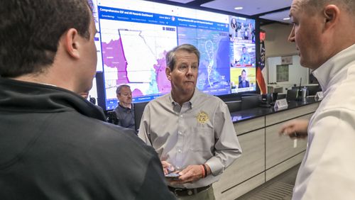 Gov. Brian Kemp talks with meteorologist Will Lanxton (left) and director Chris Stallings (right) while touring the Georgia Emergency Management and Homeland Security Agency on Sept. 28, 2022. (John Spink / AJC)