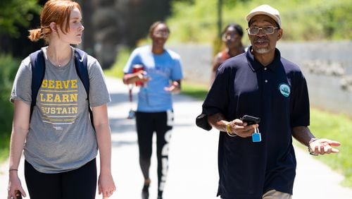 Georgia Tech student Meg Sanders, left, talks with Darryl Haddock, director of environmental education for the West Atlanta Watershed Alliance, as they use a device and app to map temperature data while walking on the Westside Beltline on Wednesday, June 15, 2022. (Ben Gray for the Atlanta Journal-Constitution)