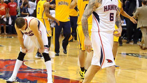 The Indiana Pacers celebrate a 91-88 victory against the the Atlanta Hawks as Pero Antic (6) walks off the court after missing a 3-pointer that would have tied the game as the Hawks' Kyle Korver, left, reacts after Game 4 of an NBA Eastern Conference quarterfinal at Philips Arena in Atlanta, Saturday, April 26, 2014. Indiana's win ties the series. (Curtis Compton/Atlanta Journal-Constitution/MCT) The reactions by Kyle Korver and Pero Antic tell the story for the end of Game 4 for the Hawks. (Curtis Compton)
